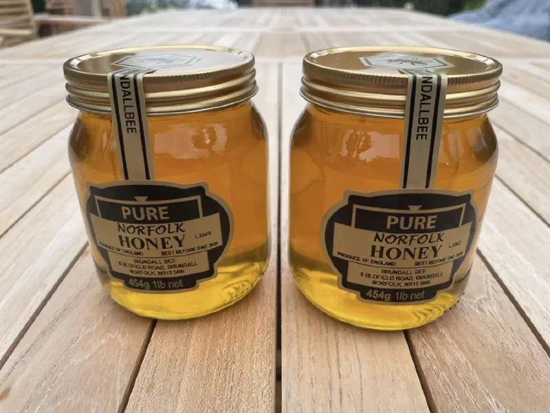 Two jars of Brundall Bee runny honey